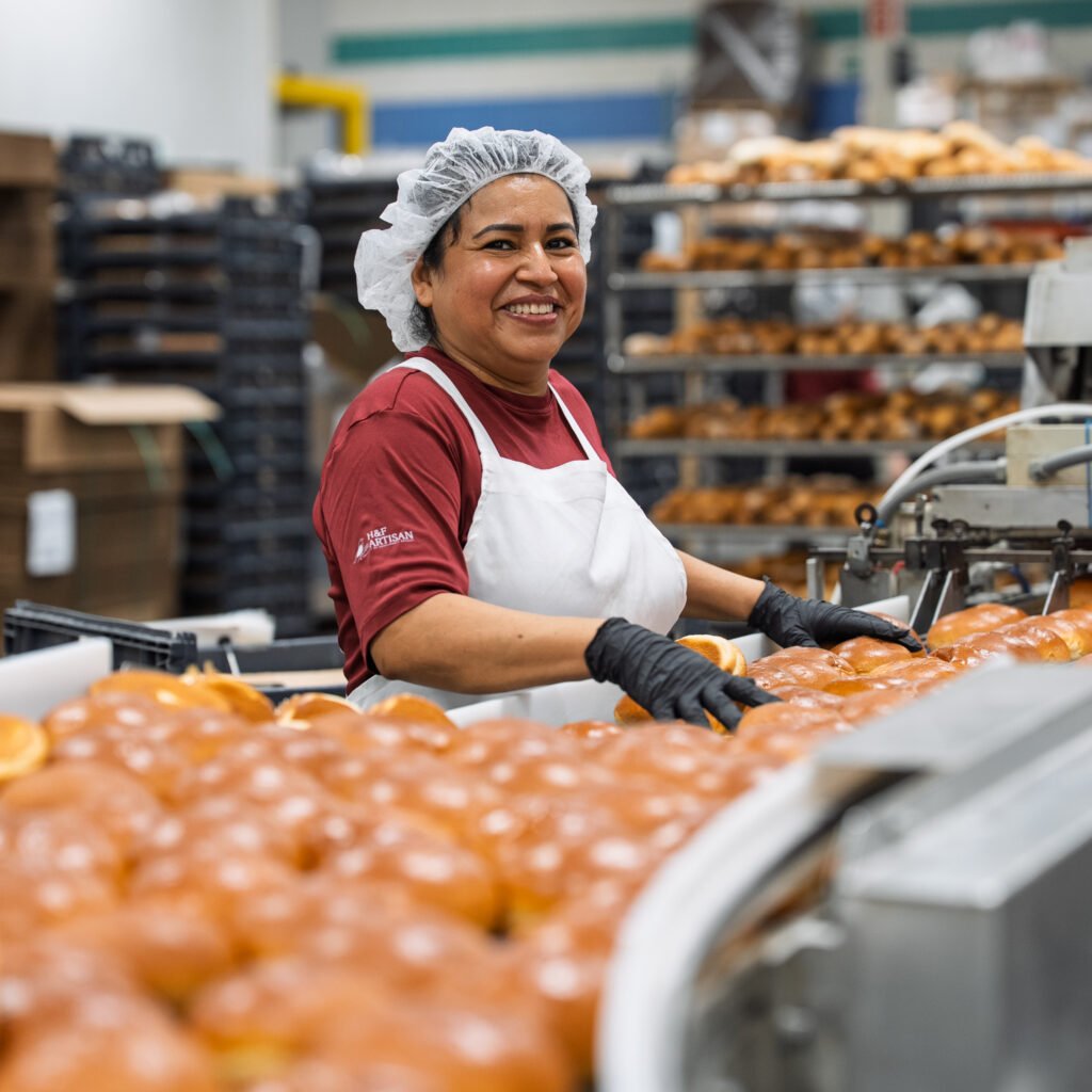 A person in Engelman’s Bakery, surrounded by racks of bread