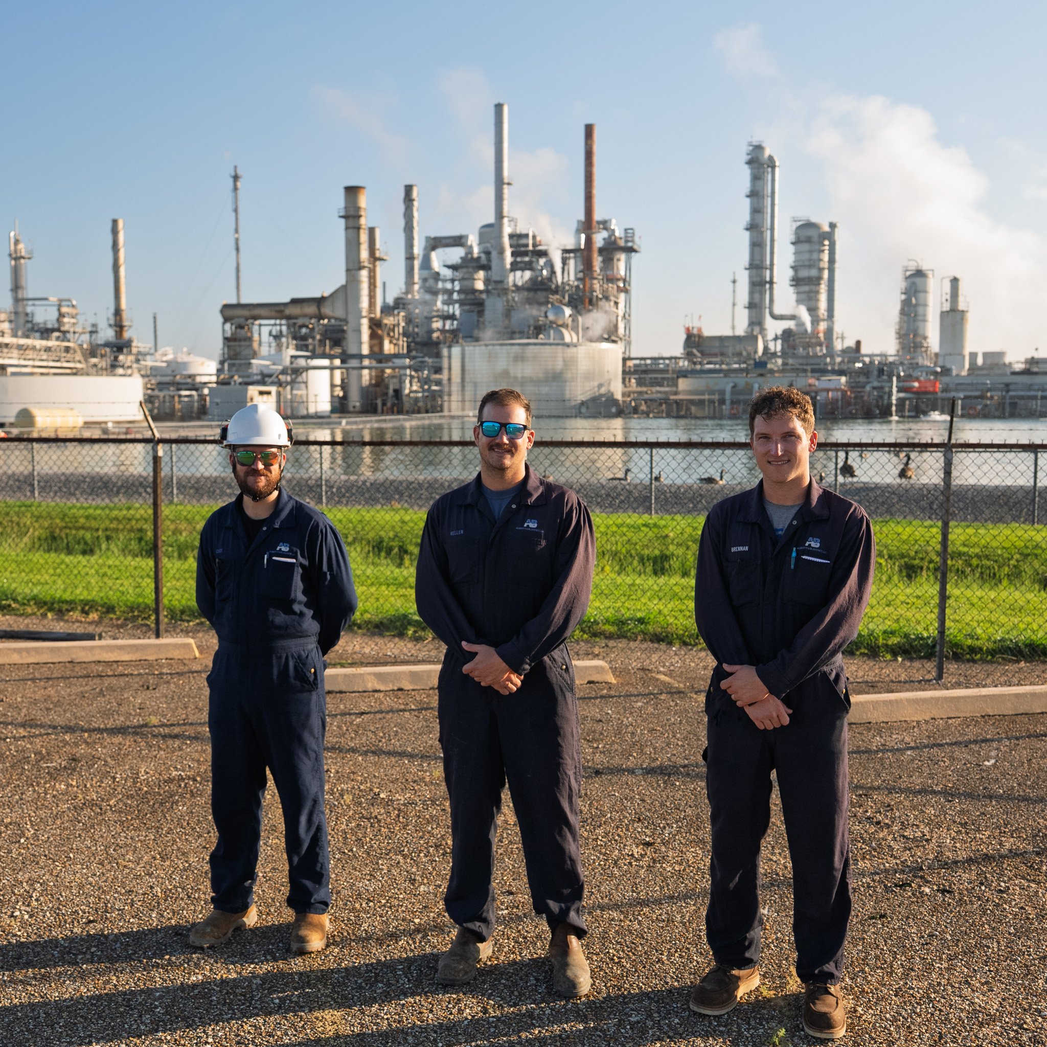 Three people at an industrial facility.