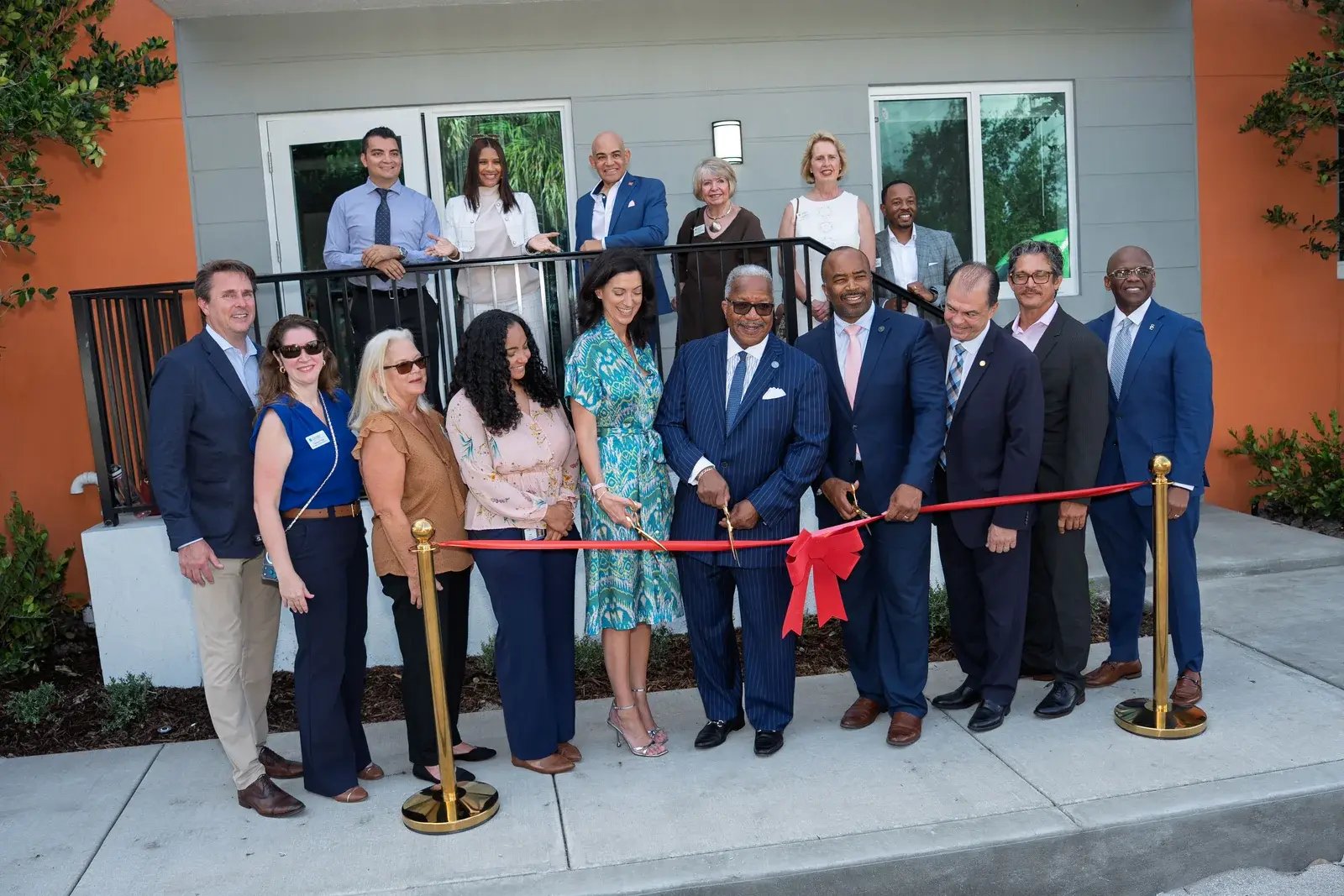 Guests gather for the Coleman Park ribbon cutting outside the completed apartment building.