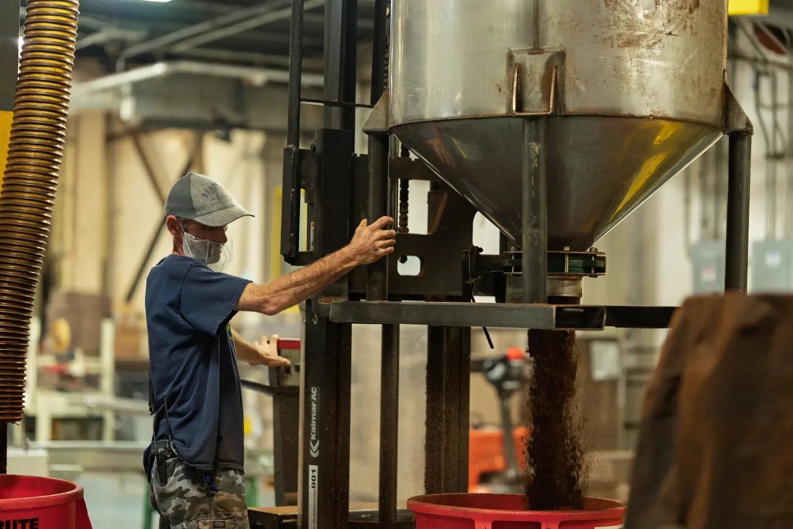 A staff member operating equipment in the Ronnoco production facility.
